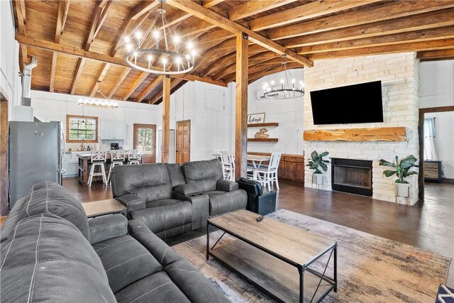 3520 Sykora Rd, Fayetteville, TX 78940 - living area featuring a chandelier, wooden ceiling, a stone fireplace, and lofted ceiling with beams