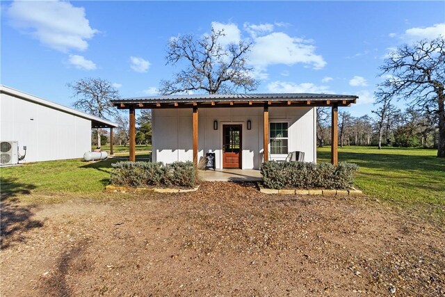 3520 Sykora Rd, Fayetteville, TX 78940 - view of front of home featuring an outbuilding, metal roof, a front lawn, and ac unit