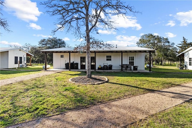 3520 Sykora Rd, Fayetteville, TX 78940 - view of front of home featuring a patio area, metal roof, and a front yard