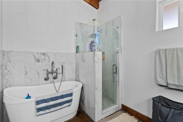 3520 Sykora Rd, Fayetteville, TX 78940 - bathroom featuring a soaking tub, a marble finish shower, and tile walls