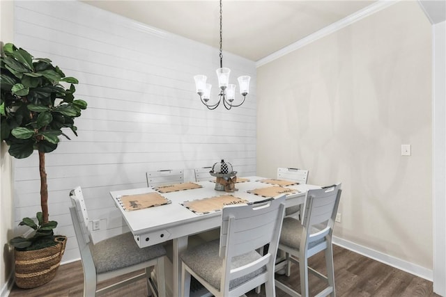 4019 Heru Ct, College Station, TX 77845 - dining space featuring crown molding, a chandelier, dark wood finished floors, and wooden walls