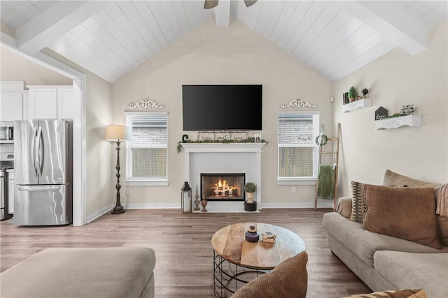 4019 Heru Ct, College Station, TX 77845 - living room featuring ceiling fan, light wood-style flooring, and a tiled fireplace