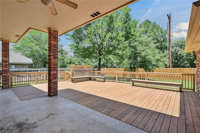 wooden deck featuring a fenced backyard and a ceiling fan
