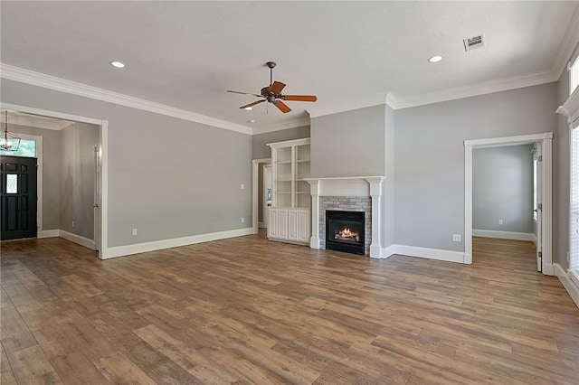 unfurnished living room with wood finished floors, a ceiling fan, baseboards, crown molding, and recessed lighting