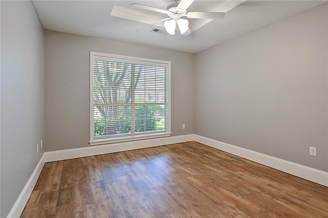 unfurnished room with wood finished floors, ceiling fan, and baseboards
