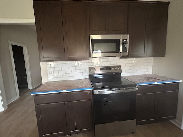 1935 Pinemont View Dr, Bryan, TX 77807 - kitchen featuring stainless steel appliances, backsplash, dark wood-style flooring, and dark brown cabinetry