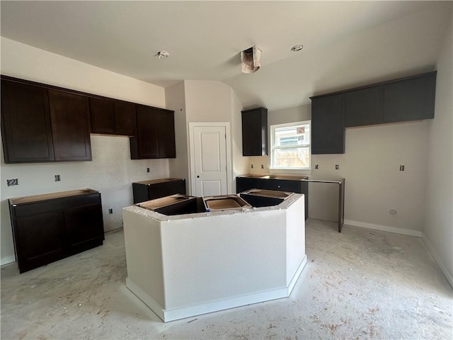 1935 Pinemont View Dr, Bryan, TX 77807 - kitchen featuring a center island, lofted ceiling, dark brown cabinetry, and baseboards