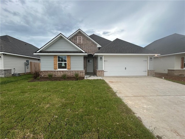 1935 Pinemont View Dr, Bryan, TX 77807 - view of front of property with brick siding, an attached garage, driveway, a front lawn, and a shingled roof