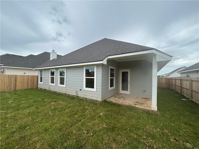 1935 Pinemont View Dr, Bryan, TX 77807 - rear view of property featuring a fenced backyard, roof with shingles, and a chimney