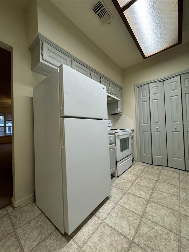 400 Nagle St Unit 304, College Station, TX 77840 - kitchen featuring white appliances, gray cabinets, light tile patterned floors, extractor fan, and light countertops