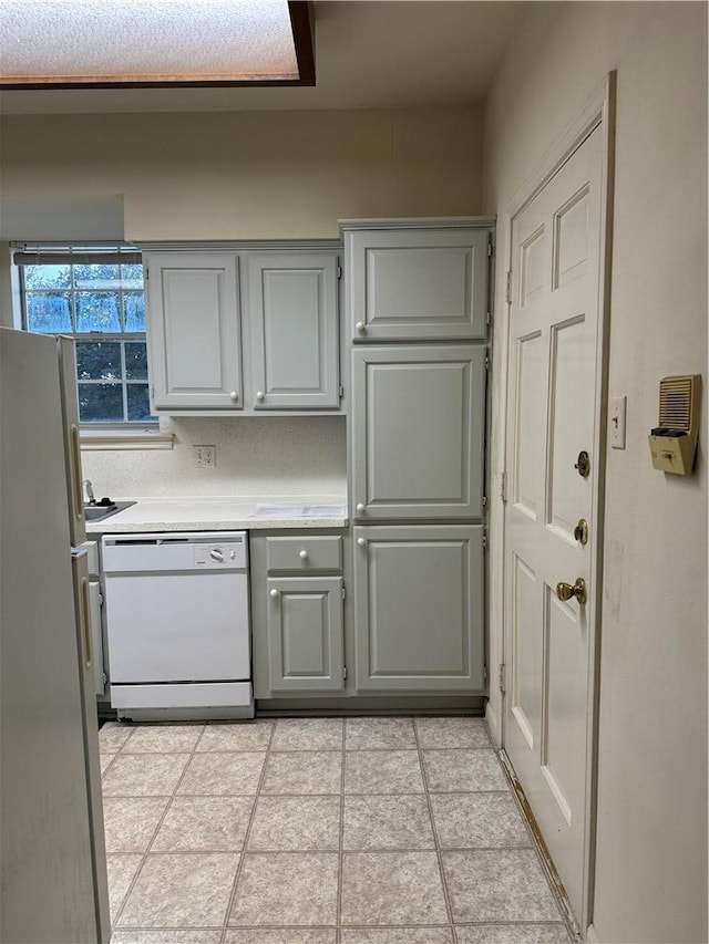 400 Nagle St Unit 304, College Station, TX 77840 - kitchen with white appliances, gray cabinets, light countertops, and light tile patterned floors