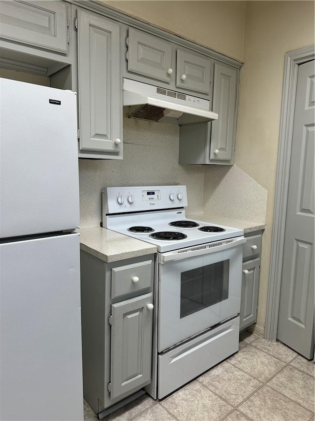 400 Nagle St Unit 304, College Station, TX 77840 - kitchen with white appliances, gray cabinets, under cabinet range hood, light countertops, and light tile patterned flooring