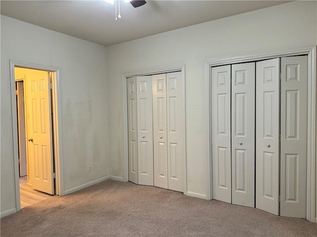 400 Nagle St Unit 304, College Station, TX 77840 - unfurnished bedroom featuring light colored carpet, two closets, and ceiling fan
