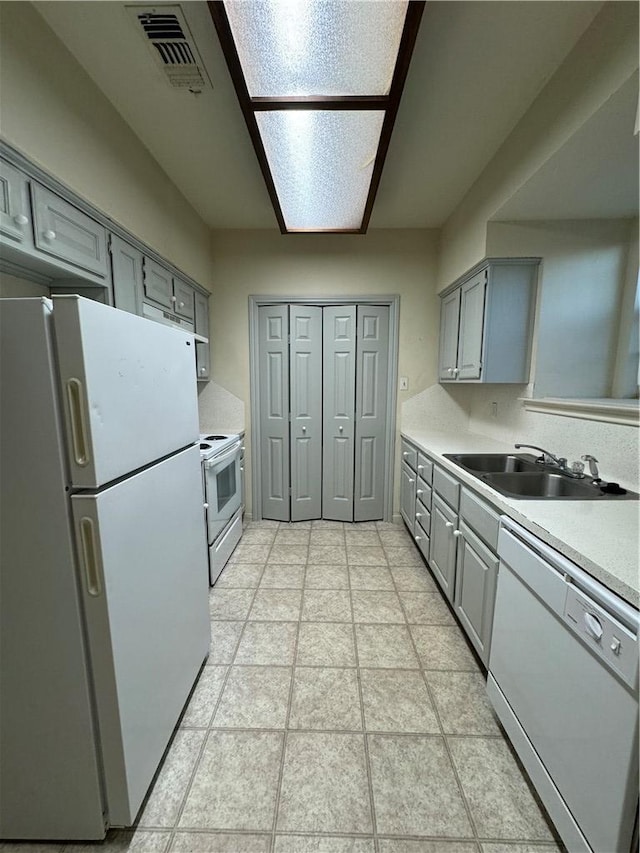 400 Nagle St Unit 304, College Station, TX 77840 - kitchen with white appliances, gray cabinets, and light countertops