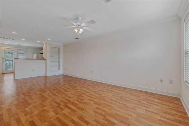 unfurnished living room featuring crown molding, built in features, ceiling fan, and light hardwood / wood-style flooring