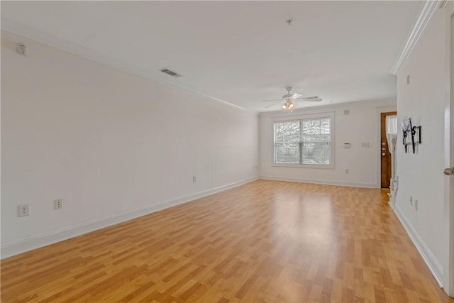 spare room featuring crown molding, ceiling fan, and light hardwood / wood-style flooring