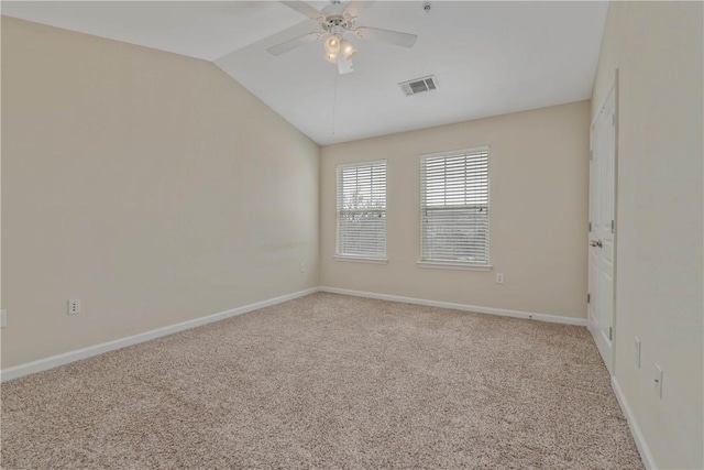 spare room featuring ceiling fan, lofted ceiling, and carpet flooring