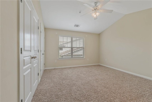 spare room with lofted ceiling, carpet flooring, and ceiling fan