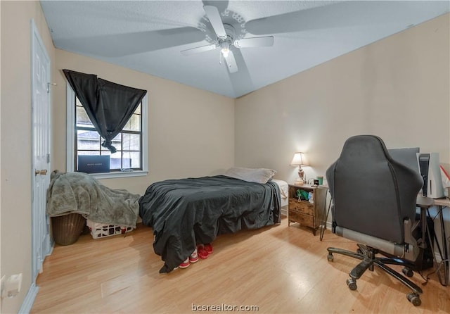 bedroom with ceiling fan and light hardwood / wood-style flooring