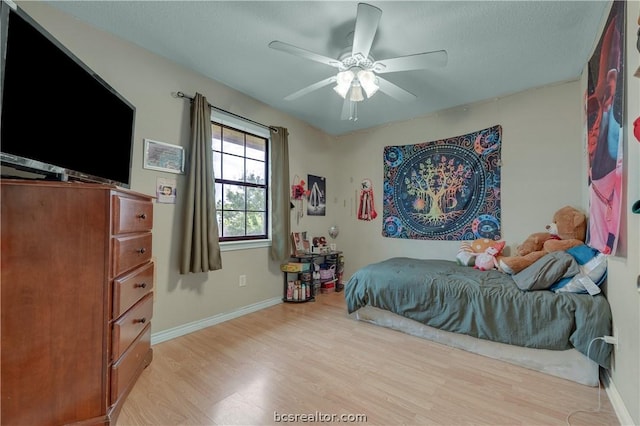 bedroom with ceiling fan and light hardwood / wood-style floors