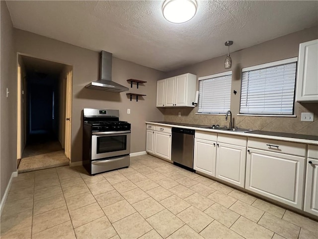 kitchen featuring white cabinetry, sink, wall chimney exhaust hood, and stainless steel appliances