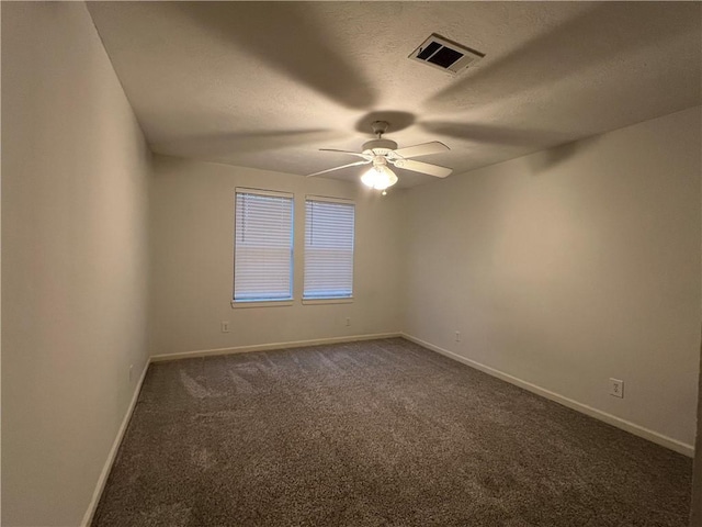 carpeted spare room with a textured ceiling and ceiling fan