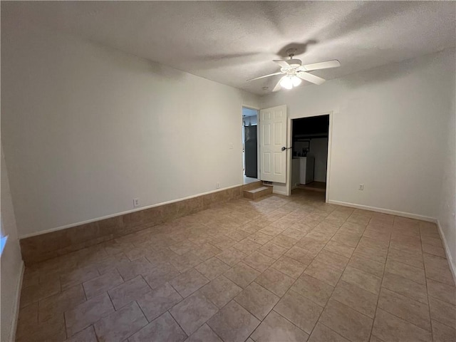 spare room featuring ceiling fan and a textured ceiling