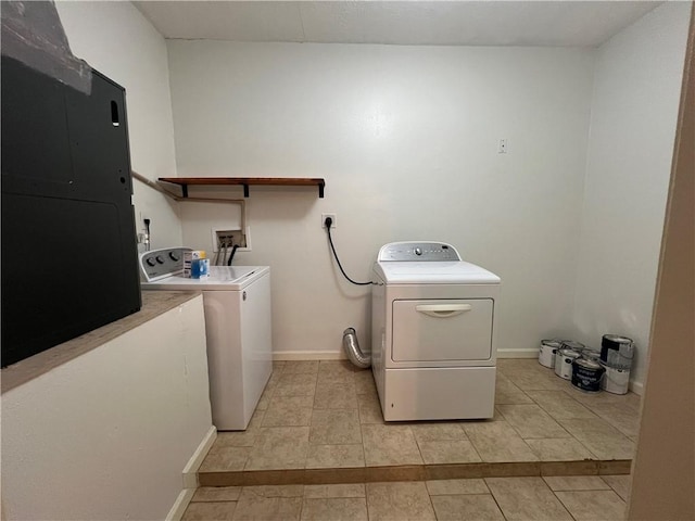 laundry area with light tile patterned floors and washing machine and clothes dryer