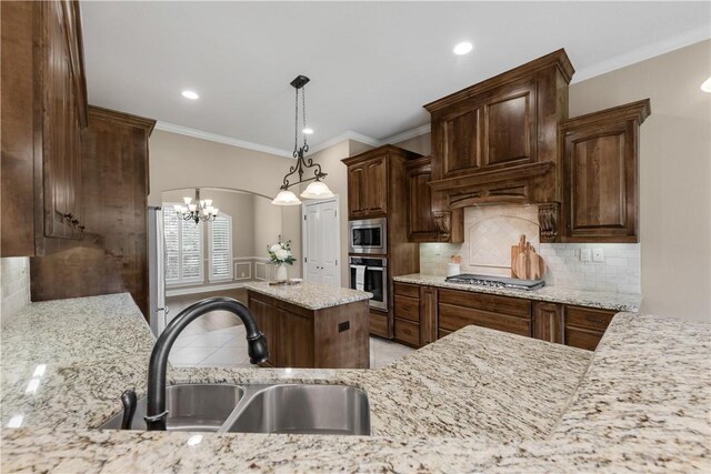 4018 Arboleda Dr, College Station, TX 77845 - kitchen with stainless steel appliances, a sink, a chandelier, ornamental molding, and backsplash