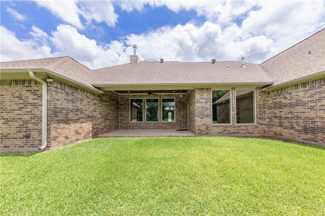 4018 Arboleda Dr, College Station, TX 77845 - rear view of property featuring brick siding, a yard, and a shingled roof
