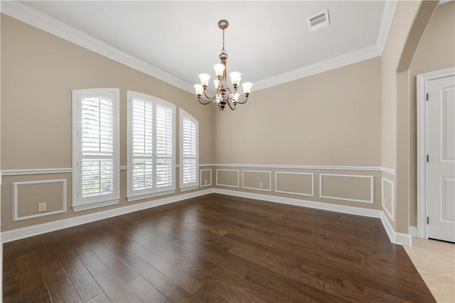 4018 Arboleda Dr, College Station, TX 77845 - spare room with a chandelier, ornamental molding, arched walkways, a wainscoted wall, and wood finished floors