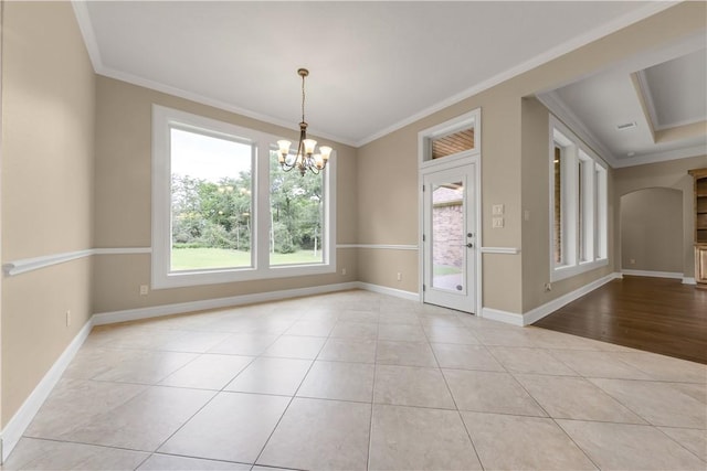 4018 Arboleda Dr, College Station, TX 77845 - unfurnished room with ornamental molding, a chandelier, baseboards, arched walkways, and tile patterned floors