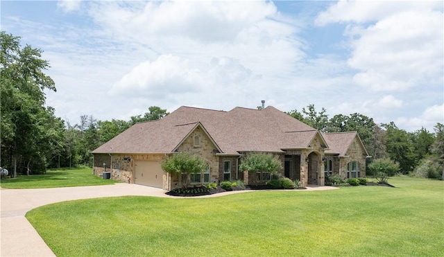 4018 Arboleda Dr, College Station, TX 77845 - french country home featuring stone siding, a front lawn, driveway, and an attached garage