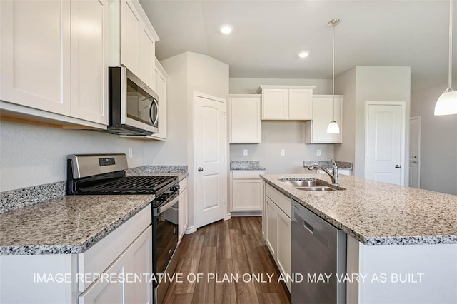 kitchen with white cabinets, hanging light fixtures, and appliances with stainless steel finishes