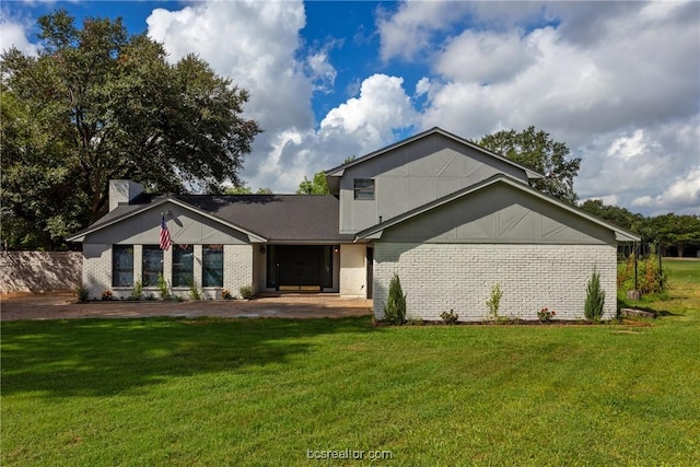 rear view of house with a lawn