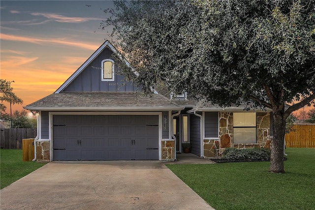 view of front of house featuring a garage and a yard