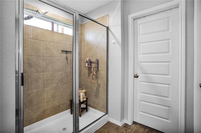 1147 Buffalograss Trl, Sealy, TX 77474 - full bathroom featuring a shower stall, wood finished floors, and baseboards