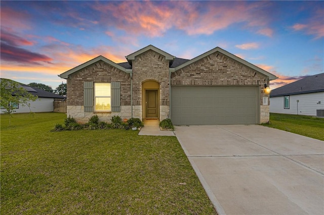 1147 Buffalograss Trl, Sealy, TX 77474 - view of front of property featuring an attached garage, a front lawn, concrete driveway, and central AC