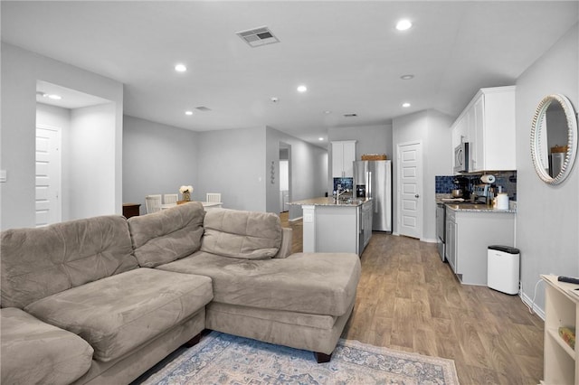 1147 Buffalograss Trl, Sealy, TX 77474 - living area with light wood finished floors, recessed lighting, and baseboards