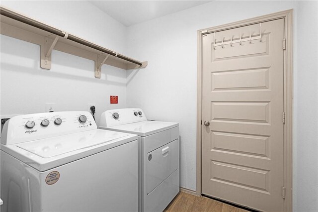 1147 Buffalograss Trl, Sealy, TX 77474 - laundry area with washing machine and clothes dryer and light wood-style flooring