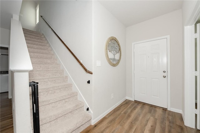 5759 Cerrillos Dr, Bryan, TX 77807 - foyer featuring stairs, wood finished floors, and baseboards