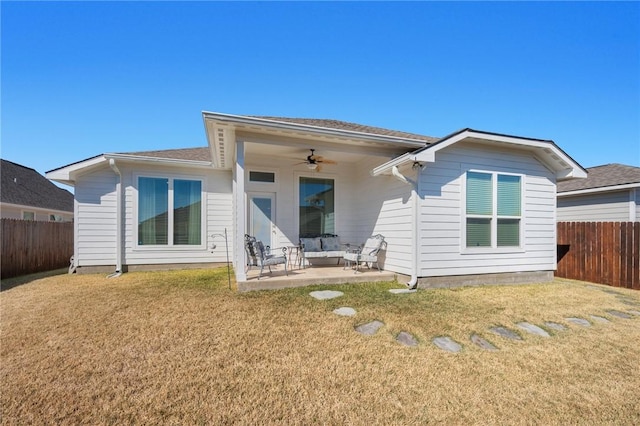 back of property featuring a patio, a yard, and ceiling fan