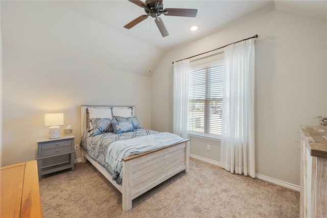 bedroom with vaulted ceiling, light carpet, and ceiling fan