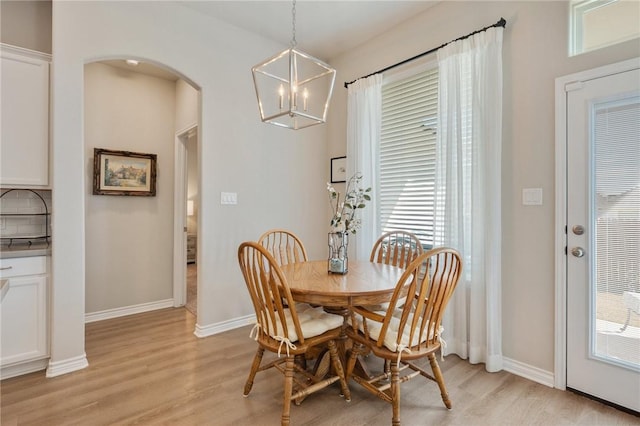 dining space featuring a notable chandelier and light hardwood / wood-style flooring