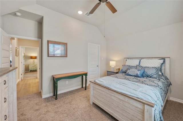 bedroom featuring ceiling fan, vaulted ceiling, and light carpet