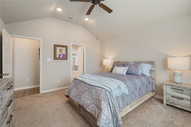 carpeted bedroom featuring ceiling fan, lofted ceiling, and connected bathroom