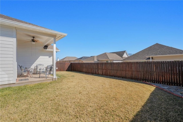 view of yard featuring a patio and ceiling fan