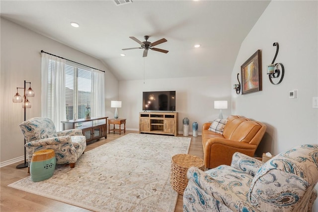 living room with lofted ceiling, light hardwood / wood-style flooring, and ceiling fan