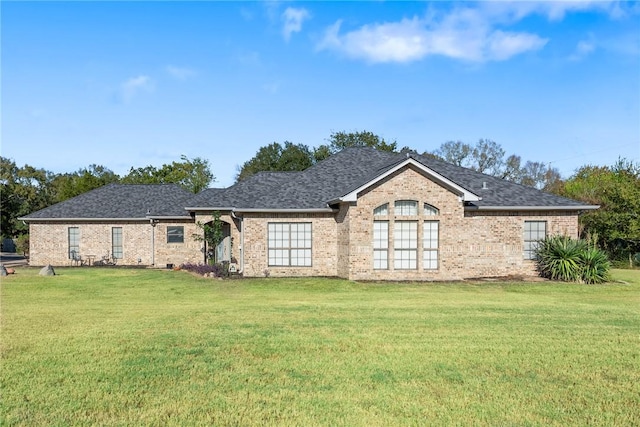 rear view of house featuring a yard