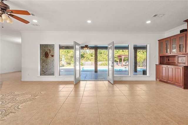 doorway to outside featuring crown molding, ceiling fan, and light tile patterned floors